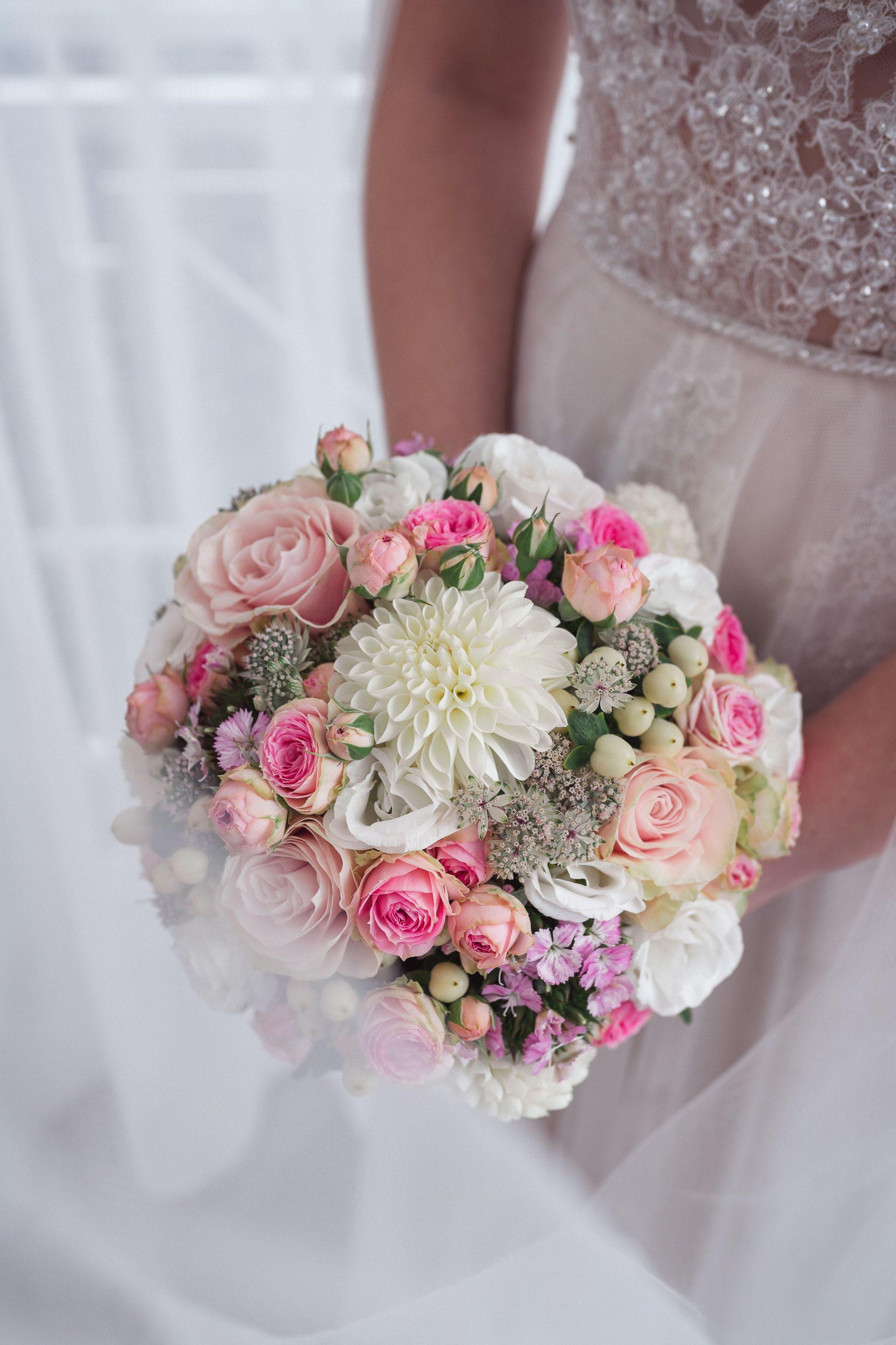 Bride holding an elegant blush and white bridal bouquet