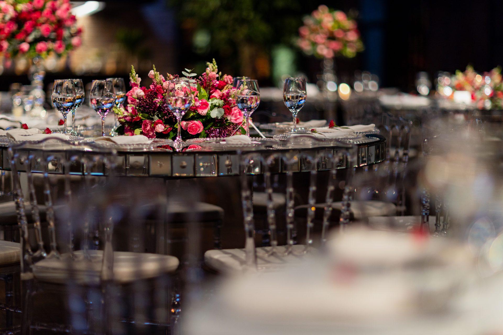 Long wedding reception table with floral runners and candles