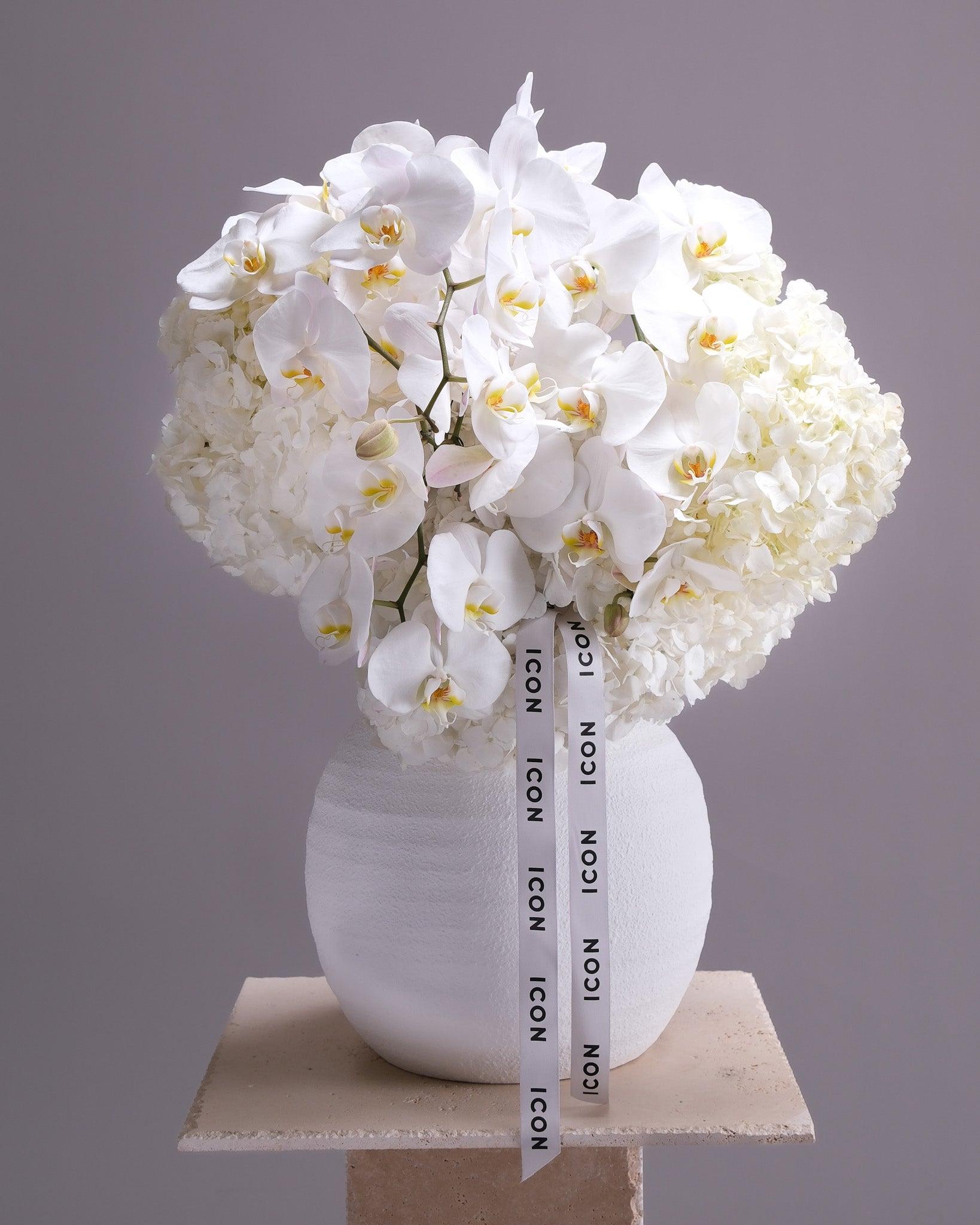 Elegant white orchid and lisianthus garden arrangement